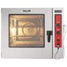 A close-up of a red and black Vulcan Full Size Electric Combi Oven with a dial and black button.