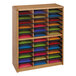 A wooden shelf with colorful paper in a Safco Oak File Organizer.