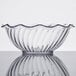 A clear glass tulip bowl with a wavy edge.