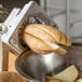 A Vollrath potato cutter wedging potatoes on a counter.