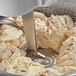 An Avancini spiral dough mixer with a bowl of dough in it.