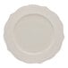 A white bone china plate with a decorative embossed rim.
