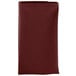 A folded burgundy Intedge cloth napkin on a white background.