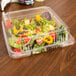 A salad in a Durable Packaging clear hinged lid plastic container.