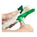 A person using a Unger green and white StripWasher to clean a window.