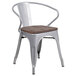 A Flash Furniture silver metal restaurant chair with a wooden seat and arms.