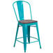 A turquoise metal restaurant bar stool with a wooden seat.