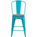 A teal-blue metal restaurant bar stool with a wood seat.