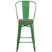 a green metal chair with a wooden base