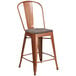 A Flash Furniture copper metal restaurant bar stool with a wood seat.