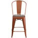 A Flash Furniture copper metal restaurant bar stool with a wooden seat and vertical slat back.