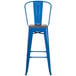 A blue metal bar stool with a wooden seat.