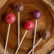 Four lollipops on cake pop sticks.