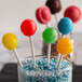 A glass vase filled with colorful Paper Lollipop Sticks.