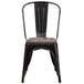 A black metal Flash Furniture restaurant chair with a wooden seat.