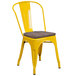 A yellow metal Flash Furniture restaurant chair with a wooden seat.