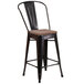 A Flash Furniture black metal counter height stool with a wooden seat.