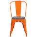 An orange Flash Furniture metal restaurant chair with a wooden seat and vertical slat back.