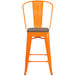 an orange chair with a wooden seat