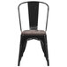 A Flash Furniture black metal chair with a wood seat.