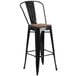 A Flash Furniture black metal bar stool with a wood seat.