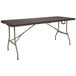 A brown rectangular Flash Furniture bi-fold table with legs.