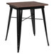 A Flash Furniture table with a wood top and black metal frame.