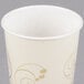 A Solo wax treated paper cold cup with a gold swirl design.