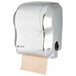 A San Jamar stainless steel look paper towel dispenser with a roll of paper.