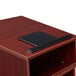 A mahogany tabletop host stand with a black tablet on it.