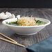 A white Eco-Products compostable noodle bowl with chopsticks on a table.