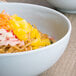 A white Thunder Group melamine soup bowl filled with noodles and vegetables.