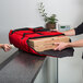 a person holding a pizza box