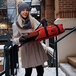 a woman carrying a red bag with a box inside