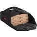 A black Cambro insulated delivery bag holding three pizza boxes.