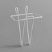 A white metal wall mount with two hooks for a Choice clear plastic utility scoop.