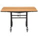 A National Public Seating square cafeteria table with wheels and a chrome frame.