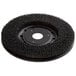 A green circular brush disc with a round center.