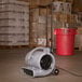 A grey B-Air air blower with wheels and a handle.