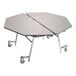 A National Public Seating octagonal cafeteria table with wheels and a grey top.