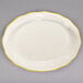 A CAC ivory china platter with scalloped edges and gold trim.