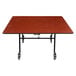 A National Public Seating square wood cafeteria table with a black frame and ProtectEdge.