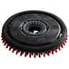 a black circular object with red bristles