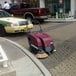 A Minuteman battery operated carpet sweeper on a gray surface.