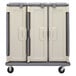 A Granite Gray Cambro meal delivery cart with three compartments and black wheels.