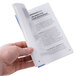 A person holding the book "Controlling Restaurant & Food Service Operating Costs"