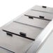 A stainless steel counter top ice cream dipping cabinet with four drawers.