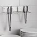 A stainless steel Edlund Smart Tong Holder with tongs in it.