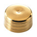 A gold-plated round cap for a cocktail shaker.