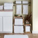 A room with white shelves holding stacks of Lavex hand towels.